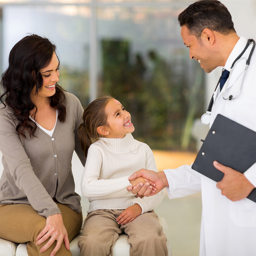 A mom and child greeting a doctor